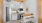 Kitchen with island/bar stools, white cabinets, pantry and subway tile backsplash